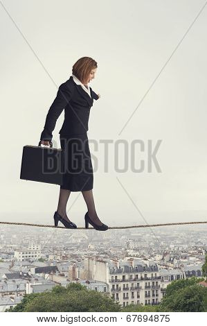 Businesswoman Walking A Tightrope