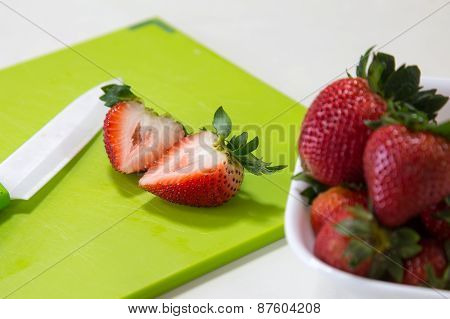 A Bowl and Slices of Strawberries