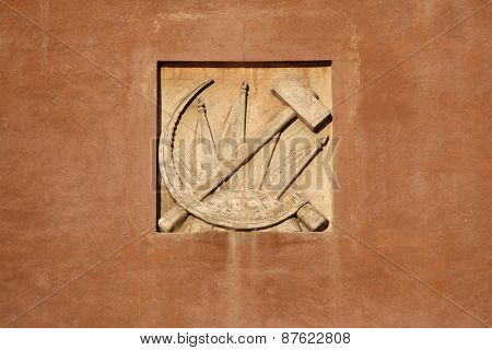 Hammer and Sickle. Stucco decoration from the Soviet era on the building in Yekaterinburg, Russia.