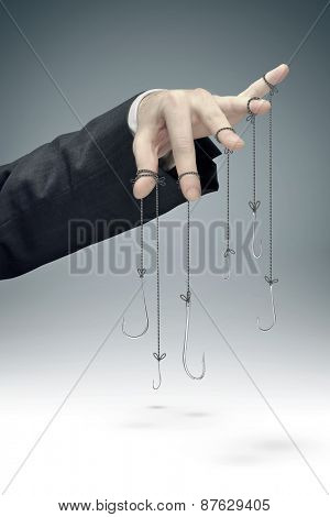 Hooks hanging on businessman hand