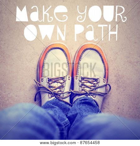  wide angle overhead shot of yellow and white boat or deck shoes with a text quote make your own path toned with a retro vintage instagram filter effect app or action 