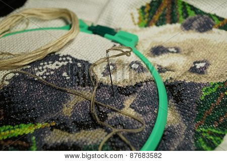 Embroidery of a picture strings of a mouline thread