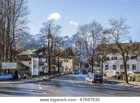 Small Alpine Town Street With Traffic And Typical Houses