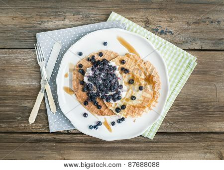 Dutch Waffles With Cream-cheese, Fresh Blueberry And Maple Syrup On A White Ceramic Plate Over A Rou