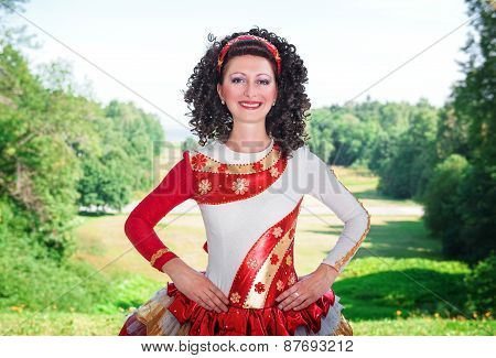 Young Woman In Red And White Irish Dance Dress And Wig Posing