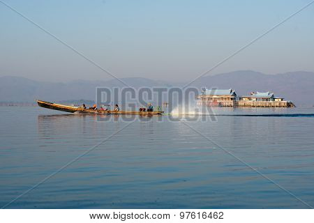 Three fishermen catches fish for food in sunrise in Inle Lake, Myanmar