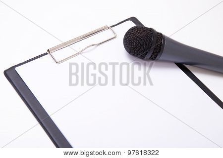 Speech Or Interview Concept - Microphone And Clipboard With Blank Paper
