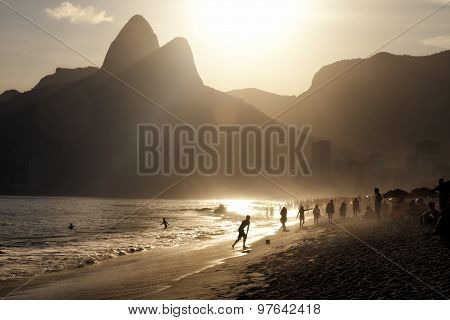 Brazilian Ipanema beach Rio de Janeiro at sunset silhouettes flare