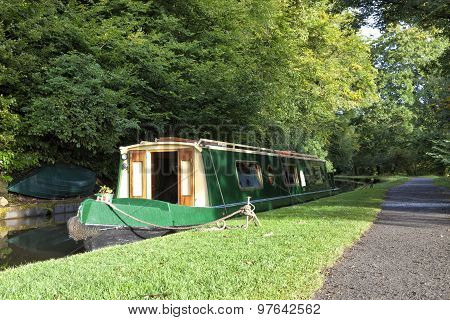 Narrow canal boat moored at canal towpath in Brecon Beacons Wales England