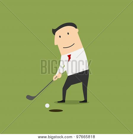 Businessman putting ball into a hole