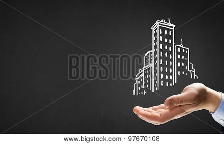 Close up of hand and drawn building model in palm