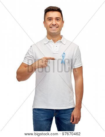 medicine, health care, gesture and people concept - smiling middle aged latin man in t-shirt with blue prostate cancer awareness ribbon pointing finger on himself