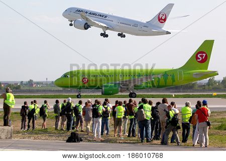 DOMODEDOVO, MOSCOW REGION, RUSSIA - MAY 25 2012: S7 airlines Airbus A319 VP-BHQ taxiing at Domodedovo international airport while JAL 787 JA826J taking off.