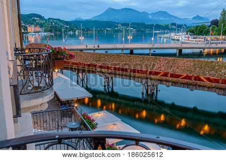 Night view towards Chapel Bridge (Kapellbruecke) together with the octagonal tall tower (Wasserturm) it is one of the Lucerne's most famous tourists attraction