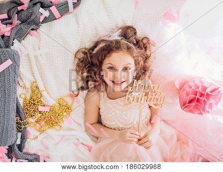 Beautiful little girl celebrating birthday party. Family celebration of the child