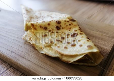 Dessert Of Pancakes On Plate On Table With Eggs