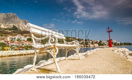 white bank on a mediterranean wharf with a town in the background