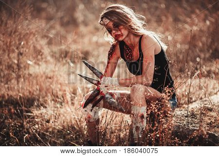 Mutant girl in wounds and ulcers with claws instead of fingers. She is sitting.
