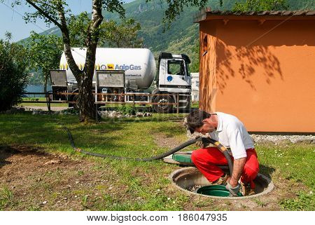 Worker Making Gas Supply On A Tank In The Garden