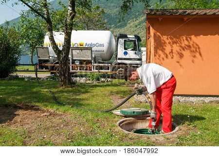 Worker Making Gas Supply On A Tank In The Garden