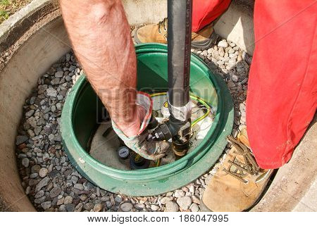 Worker Making Gas Supply On A Tank In The Garden