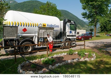 Melano Switzerland -20 May 2005: worker making gas supply on a tank in the garden of a house at Melano on Switzerland