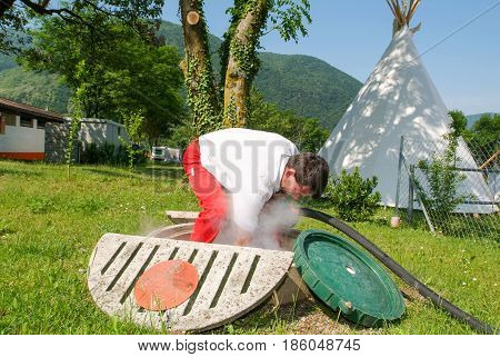 Worker Making Gas Supply On A Tank In The Garden