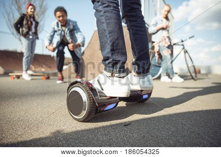 Stylish Hipster Boy Riding Gyroboard With Friends Near By, Teenagers Having Fun Concept