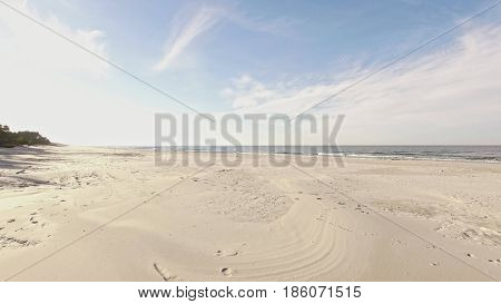 Aerial view of Baltic sea shore, waves and sandy beach. Lubiatowo, Poland