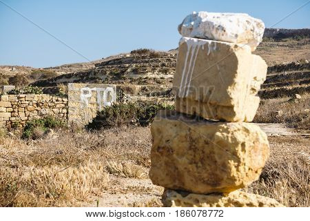 Painted sign indicating supposedly private land in Malta Gozo. RTO painted in white on a rural building.