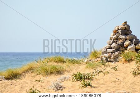 Pebble mound on a sand dune at Malia beach in Crete