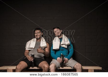 Handsome Young Athletes Resting At Gym Locker Room