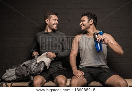 Handsome Young Athletes Resting At Gym Locker Room