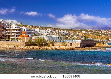 Eastern Orthodox Church of Holy Chapel Of Saint Nicholas. Place of worship on coast of Kolpos Almirou in Greek resort Rethymno. Promenade Leof. Emmanouil Kefalogianni is washed by Cretan sea. Greece
