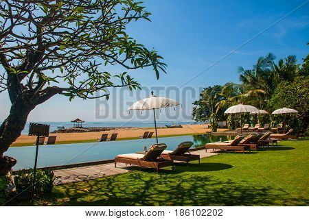 Sun Loungers And Parasols On The Beach, Pool. Bali, Indonesia, Tanjung Benoa. Nusa Dua.