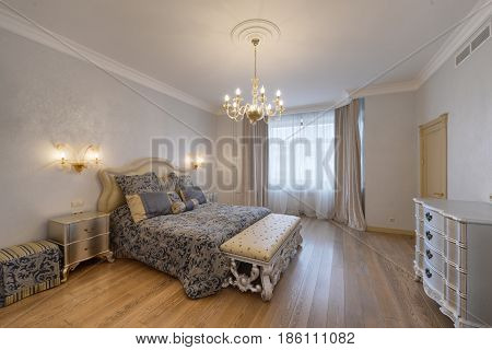 Russia, Moscow - modern designer renovation in a luxury building. Stylish bedroom interior with double bed.