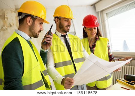 Three Arhitects Working Together On Construction Site Project