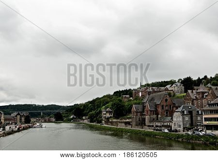Landscape of Meuse River and Side View on Maison Leffe in Cloudy Day Outdoors. Dinant Belgium