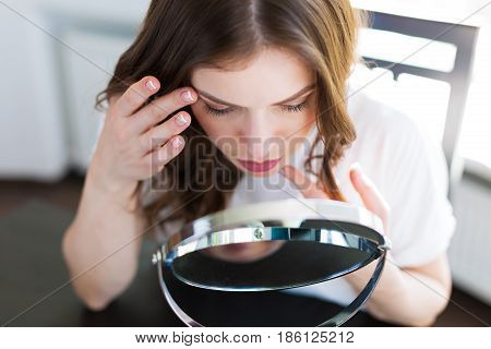 Woman Sitting By The Mirror