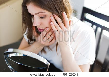 Woman Sitting By The Mirror