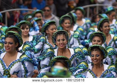ORURO, BOLIVIA - FEBRUARY 26, 2017: Caporales dancers in ornate costumes performing as they parade through the mining city of Oruro on the Altiplano of Bolivia during the annual carnival.