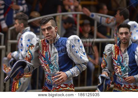ORURO, BOLIVIA - FEBRUARY 26, 2017: Caporales dancers in ornate costumes performing as they parade through the mining city of Oruro on the Altiplano of Bolivia during the annual carnival.