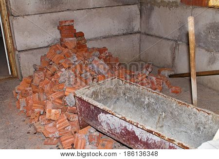 Pile of Bricks by an Old Brick Wall taken by an old building in St. Petersburg. Building trough for concrete