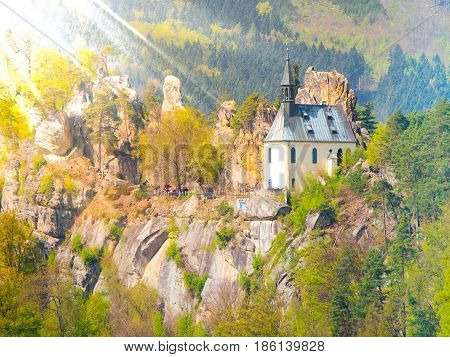 Ruins of Vranov Castle with small rock chapel, Pantheon, in Mala Skala on sunny summer day with blue sky and lush green trees, Bohemian Paradise, aka Cesky Raj, Czech Republic, Europe.