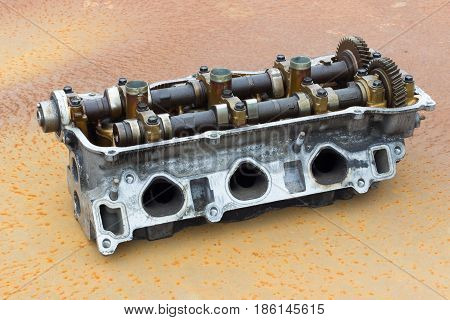 old engine Cylinder head on rusty steel
