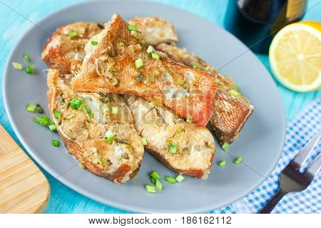 Steamed snapper (pacific ocean perch sea bass ruby perch) with soy sauce lemon ginger and parsley in Asian style. Healthy cooking