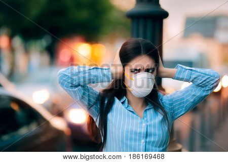 Girl With Mask Covering her Ears Because of Noise Pollution