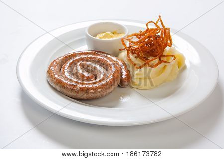 Mashed Potato And Roasted Sausage Or Bratwurst On White Plate
