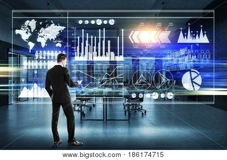 Rear view of businessman in a suit looking at graphs on a glassboard.  3d rendering toned image