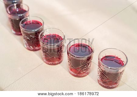 Many alcoholic cocktail drinks with crainberry or strawberry on pub bar